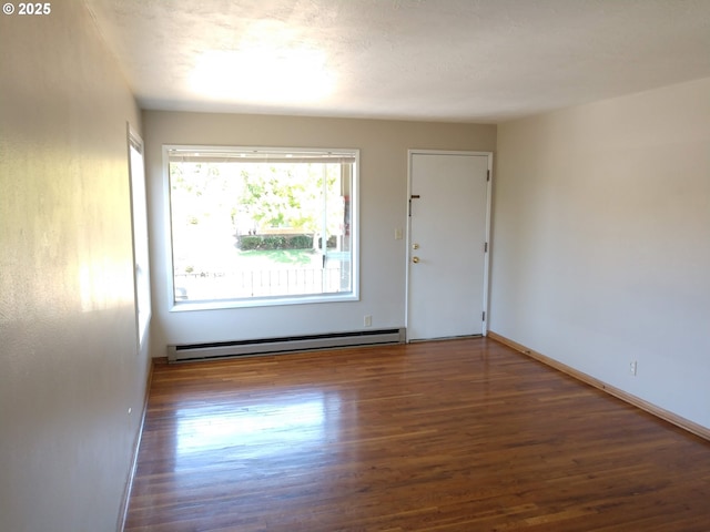 923 S Fir St, Salem, OR 97302 - spare room with a baseboard heating unit, wood finished floors, and baseboards