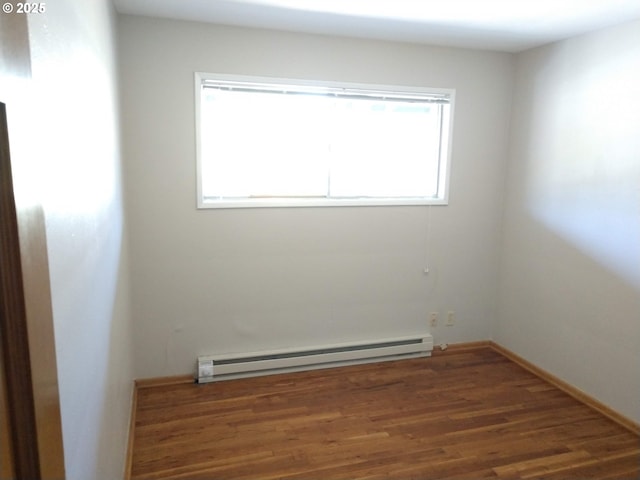 923 S Fir St, Salem, OR 97302 - empty room featuring a baseboard radiator, healthy amount of natural light, and wood finished floors