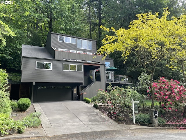 3318 SW 44th Ave, Portland, OR 97221 - view of front of home featuring a garage, driveway, stairway, and board and batten siding
