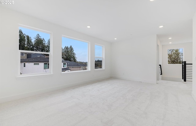 carpeted spare room featuring recessed lighting and baseboards