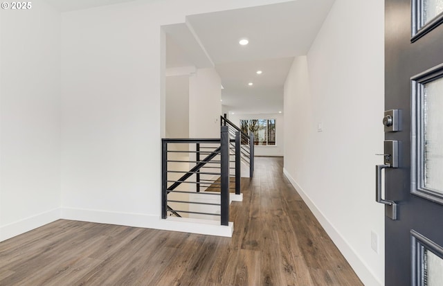 hall featuring recessed lighting, wood finished floors, and baseboards