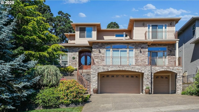 6147 Quail Hollow St, Salem, OR 97306 - view of front of house with a balcony, stone siding, an attached garage, concrete driveway, and stairway