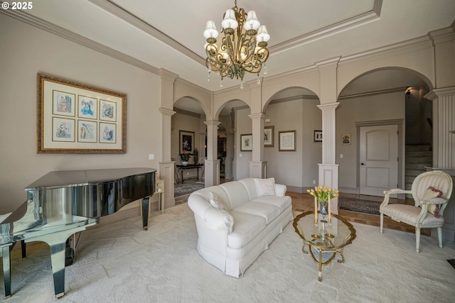 6147 Quail Hollow St, Salem, OR 97306 - carpeted living area with ornate columns, arched walkways, a raised ceiling, a chandelier, and crown molding