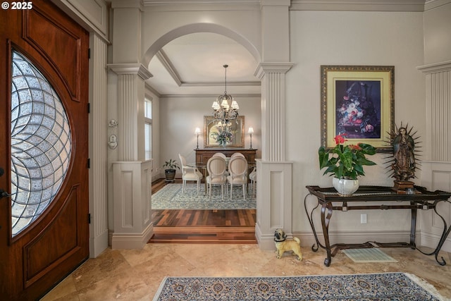 6147 Quail Hollow St, Salem, OR 97306 - entryway featuring ornate columns, arched walkways, a chandelier, ornamental molding, and marble finish flooring
