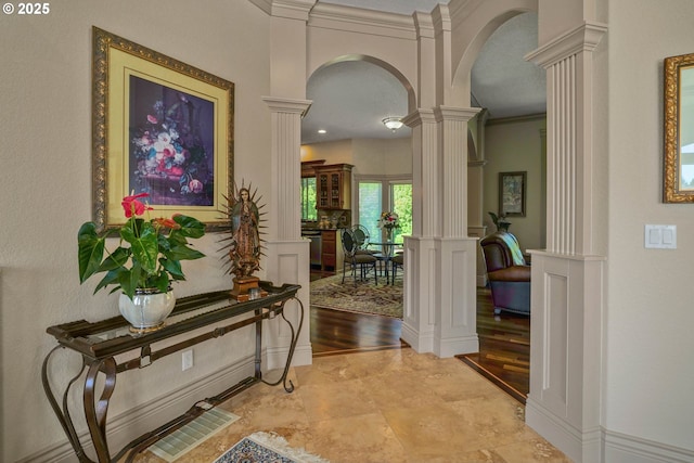 6147 Quail Hollow St, Salem, OR 97306 - hall featuring ornate columns, arched walkways, a decorative wall, a wainscoted wall, and crown molding