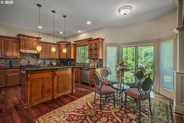 6147 Quail Hollow St, Salem, OR 97306 - kitchen featuring stainless steel appliances, dark countertops, brown cabinets, tasteful backsplash, and glass insert cabinets