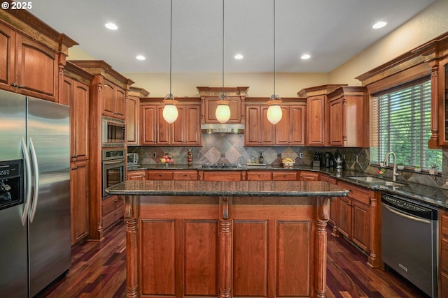 6147 Quail Hollow St, Salem, OR 97306 - kitchen featuring appliances with stainless steel finishes, dark wood-style floors, a kitchen island, under cabinet range hood, and tasteful backsplash