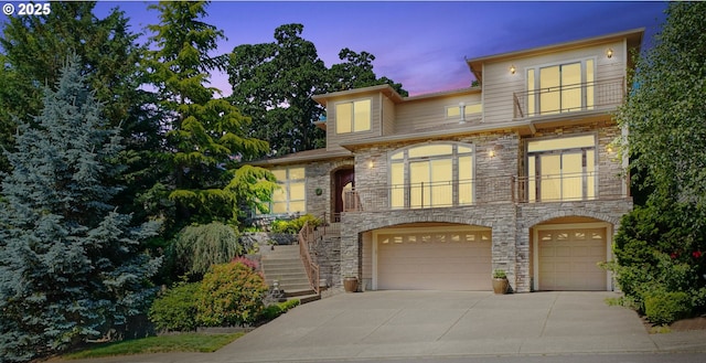6147 Quail Hollow St, Salem, OR 97306 - view of front of home with stone siding, an attached garage, stairs, concrete driveway, and a balcony