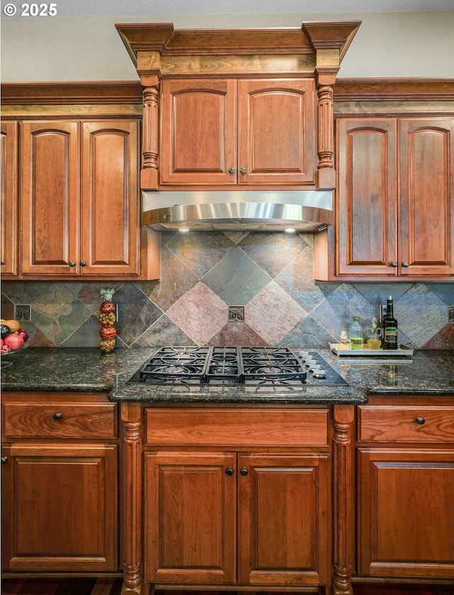 6147 Quail Hollow St, Salem, OR 97306 - kitchen featuring black gas stovetop, ventilation hood, tasteful backsplash, and dark stone counters