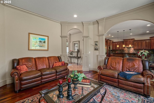 6147 Quail Hollow St, Salem, OR 97306 - living room featuring ornate columns, arched walkways, dark wood-style flooring, recessed lighting, and ornamental molding