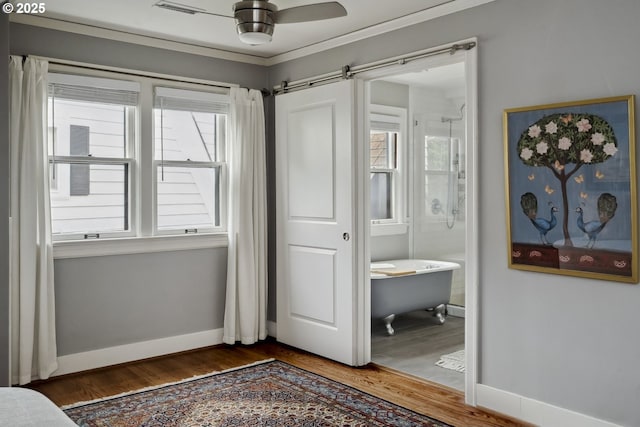 3622 NE Hassalo St, Portland, OR 97232 - bedroom with wood finished floors, a barn door, and ensuite bath