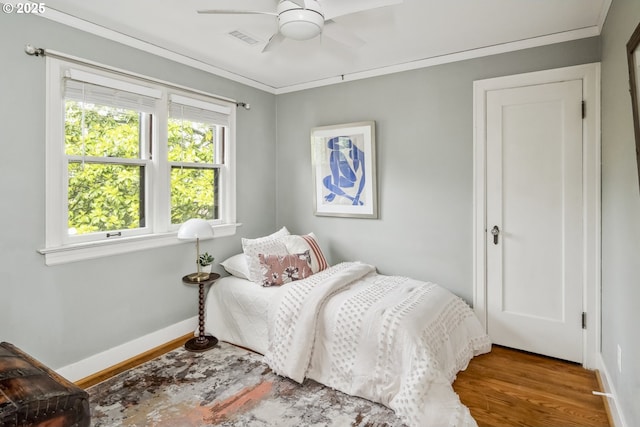 3622 NE Hassalo St, Portland, OR 97232 - bedroom with wood finished floors, crown molding, and a ceiling fan