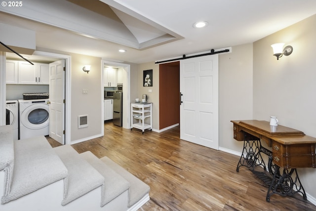 3622 NE Hassalo St, Portland, OR 97232 - living room with a barn door, recessed lighting, independent washer and dryer, and wood finished floors