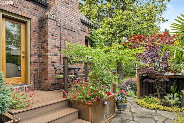 3622 NE Hassalo St, Portland, OR 97232 - view of exterior entry with brick siding and a deck