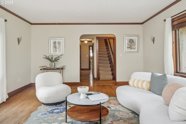 3622 NE Hassalo St, Portland, OR 97232 - living room featuring arched walkways, light wood-type flooring, stairway, ornamental molding, and plenty of natural light