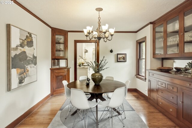 3622 NE Hassalo St, Portland, OR 97232 - dining area with light wood finished floors, crown molding, and a chandelier