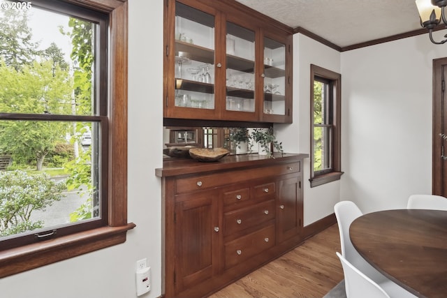3622 NE Hassalo St, Portland, OR 97232 - dining room with light wood-style flooring, ornamental molding, healthy amount of natural light, and a textured ceiling
