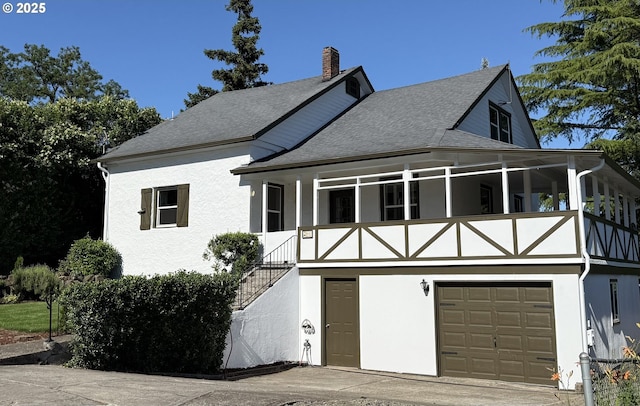 632 SW Utah St, Camas, WA 98607 - view of front of property featuring a garage, roof with shingles, stucco siding, and a chimney