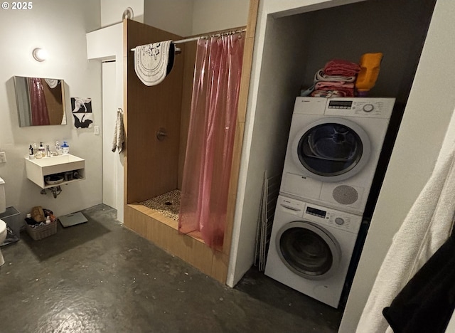 1314 NW Irving St Unit 613, Portland, OR 97209 - full bathroom featuring estacked washer and dryer, unfinished concrete floors, a shower stall, and a sink
