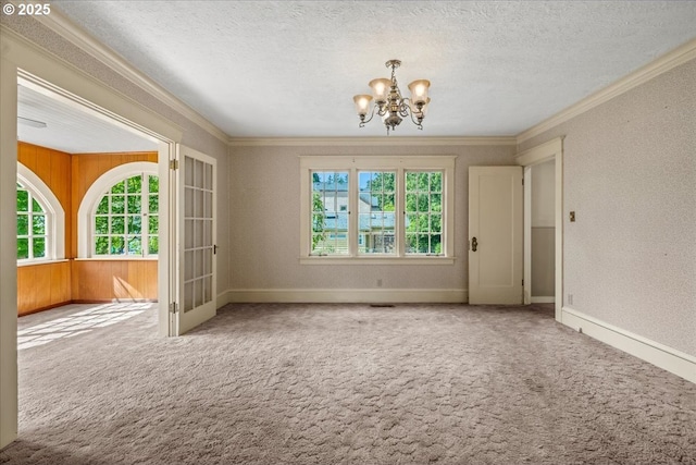 4623 SW Garden Home Rd, Portland, OR 97219 - carpeted spare room with a chandelier, healthy amount of natural light, ornamental molding, baseboards, and a textured ceiling
