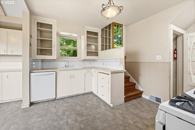 4623 SW Garden Home Rd, Portland, OR 97219 - kitchen with white dishwasher, a sink, light countertops, glass insert cabinets, and a wainscoted wall