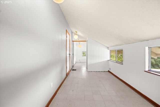 4623 SW Garden Home Rd, Portland, OR 97219 - hallway with light flooring, vaulted ceiling, and baseboards
