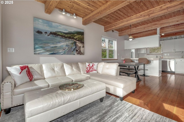 living area with wood ceiling, beam ceiling, and hardwood / wood-style flooring