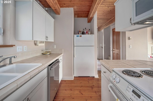 kitchen with white appliances, white cabinets, wooden ceiling, light wood-style flooring, and beamed ceiling