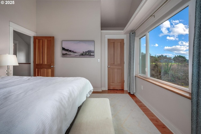 bedroom with light wood-style flooring and baseboards