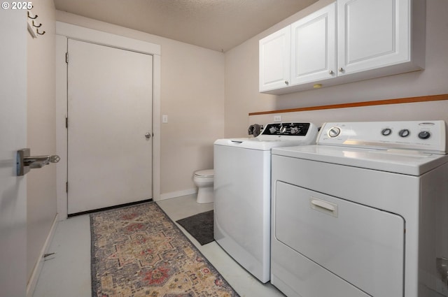 laundry area with a textured ceiling, laundry area, separate washer and dryer, and baseboards