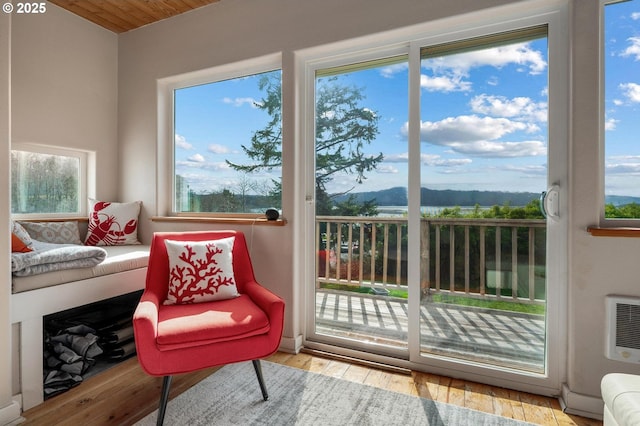 sunroom featuring heating unit and a mountain view