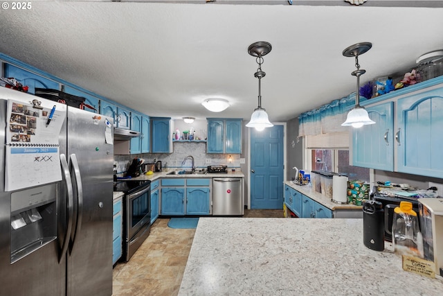 kitchen featuring pendant lighting, sink, stainless steel appliances, tasteful backsplash, and blue cabinets