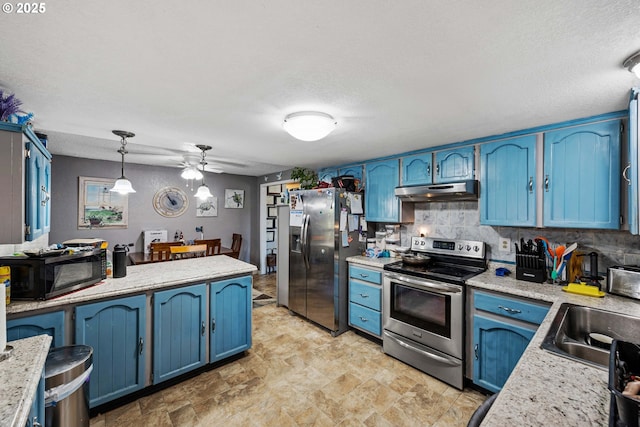 kitchen with pendant lighting, stainless steel appliances, sink, and blue cabinetry