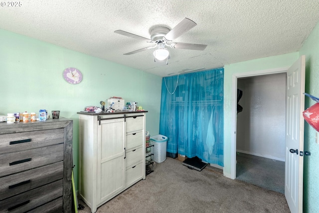 carpeted bedroom with a textured ceiling and ceiling fan