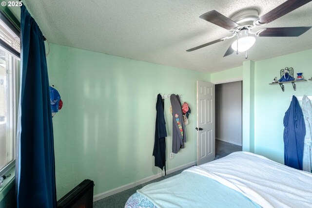 bedroom featuring ceiling fan, a textured ceiling, and carpet flooring