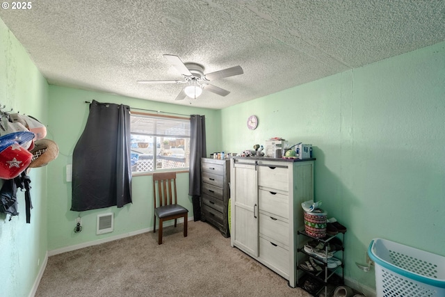 bedroom with ceiling fan, light carpet, and a textured ceiling