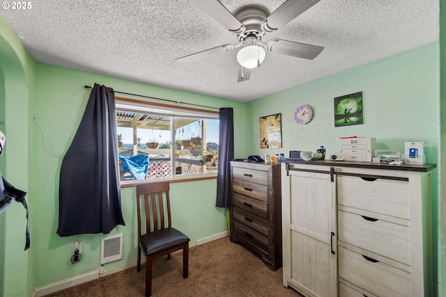 interior space featuring ceiling fan, light colored carpet, and a textured ceiling