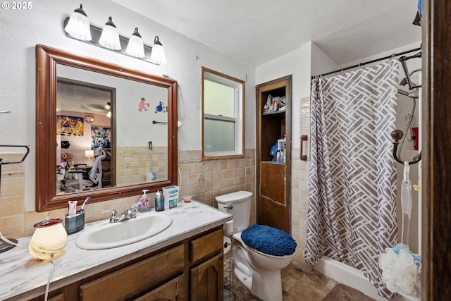 bathroom featuring a shower with curtain, vanity, tile walls, and toilet