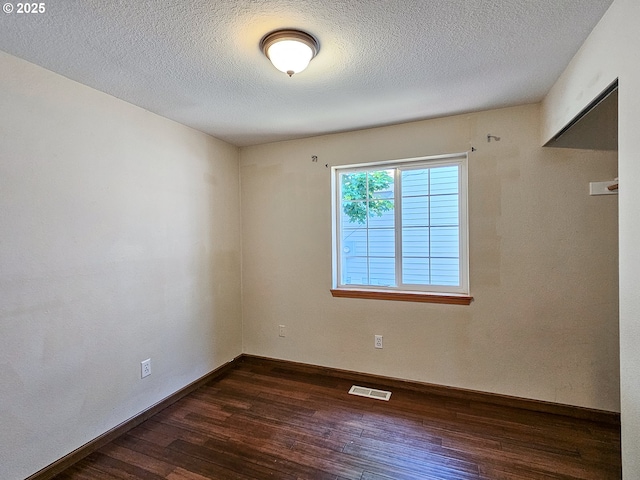 1684 NE 87th Ave, Hillsboro, OR 97006 - unfurnished room with dark wood-style flooring, baseboards, and a textured ceiling
