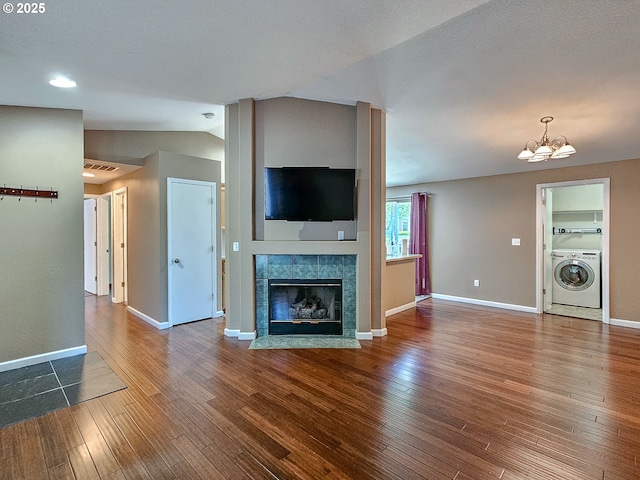 1684 NE 87th Ave, Hillsboro, OR 97006 - unfurnished living room with washer / clothes dryer, dark wood-style flooring, a chandelier, vaulted ceiling, and a fireplace