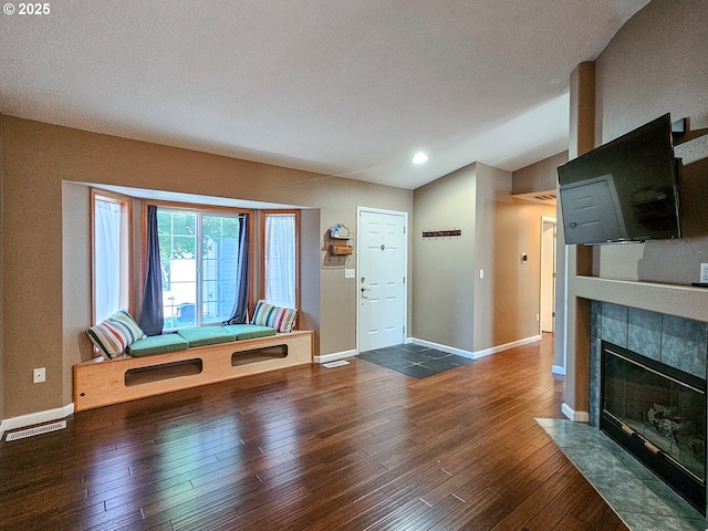 1684 NE 87th Ave, Hillsboro, OR 97006 - unfurnished living room featuring hardwood / wood-style floors, baseboards, a tile fireplace, recessed lighting, and lofted ceiling