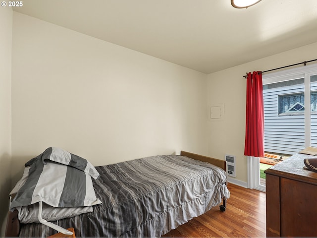 1560 S Downing St, Seaside, OR 97138 - bedroom with wood finished floors, heating unit, and baseboards