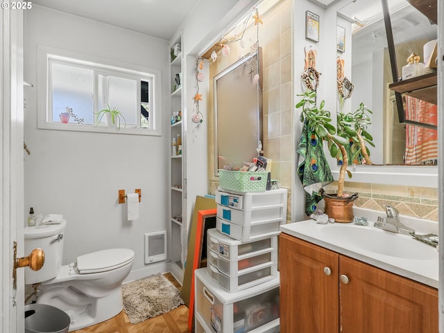 1560 S Downing St, Seaside, OR 97138 - bathroom featuring vanity, toilet, and heating unit