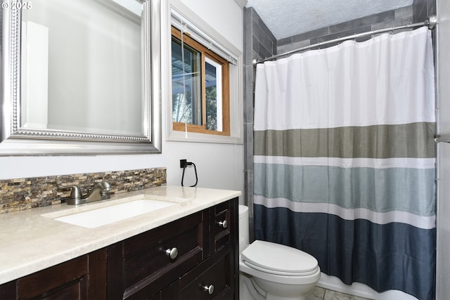 bathroom featuring toilet, vanity, and a shower with shower curtain