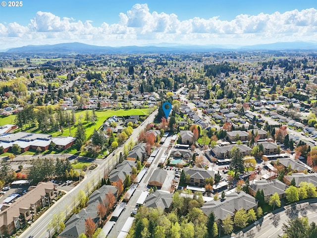 aerial view of property's location with nearby suburban area and a mountain backdrop