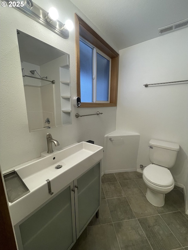 61476 Dee Cox Rd, Heppner, OR 97836 - full bathroom with toilet, vanity, tile patterned floors, and a shower