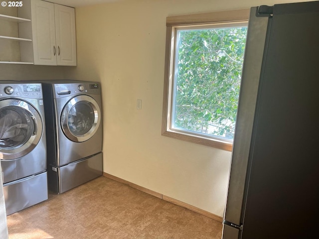 61476 Dee Cox Rd, Heppner, OR 97836 - laundry room featuring cabinet space, independent washer and dryer, light colored carpet, and baseboards