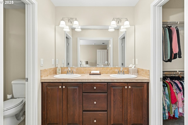 15971 NW Hildago Ln, Portland, OR 97229 - bathroom with double vanity, a spacious closet, and tasteful backsplash