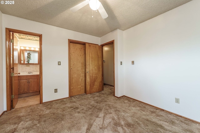 1938 NW Sierra Ln, Camas, WA 98607 - unfurnished bedroom featuring light carpet, a closet, ensuite bathroom, a textured ceiling, and ceiling fan