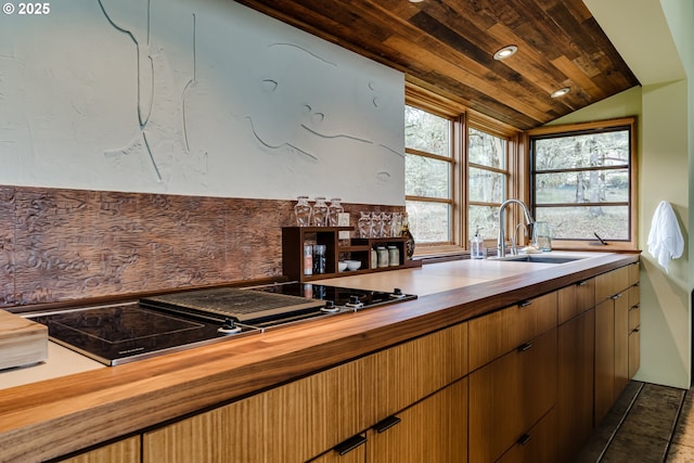 85789 Allbritain Ln, Eugene, OR 97405 - kitchen with butcher block countertops, vaulted ceiling, and black electric cooktop